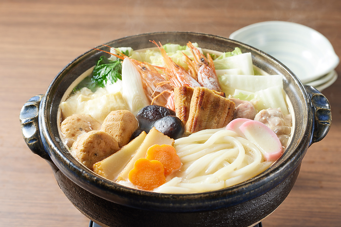 seafood and vegetables cooked sukiyaki style and served with udon
