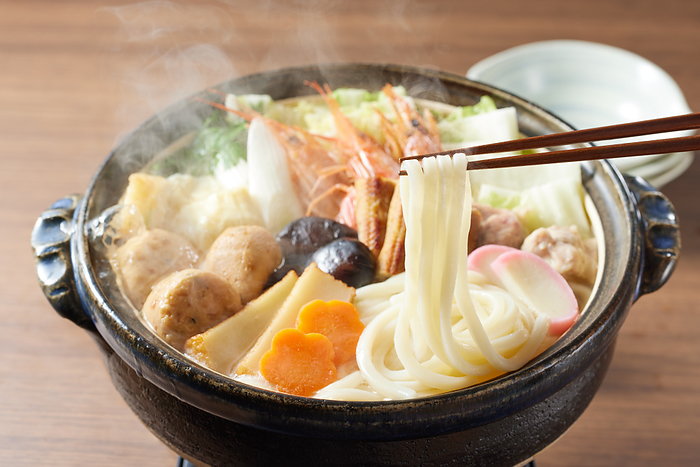 seafood and vegetables cooked sukiyaki style and served with udon