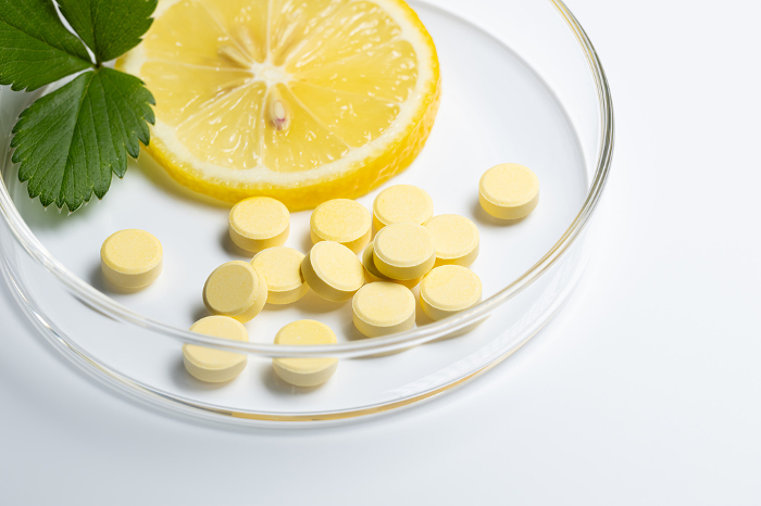 Lemon with Vitamin Supplement White Background