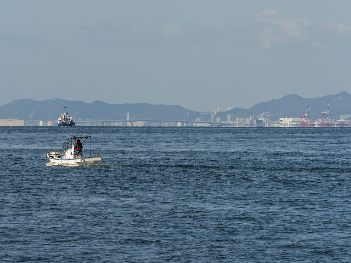 A small fishing boat proceeding through Osaka Harbor