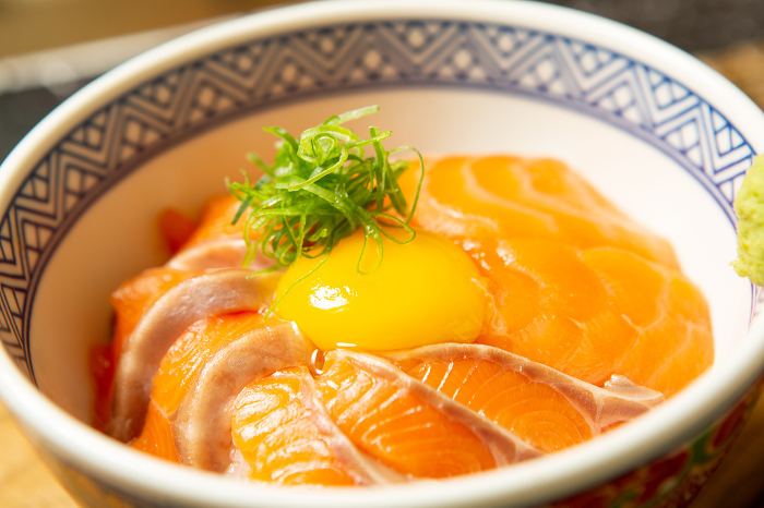 Salmon bowl topped with egg yolk