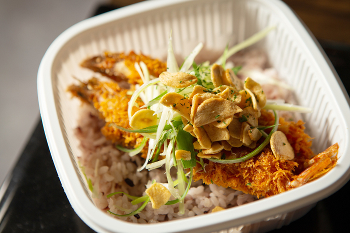 Fried shrimp rice bowl in a packaging container