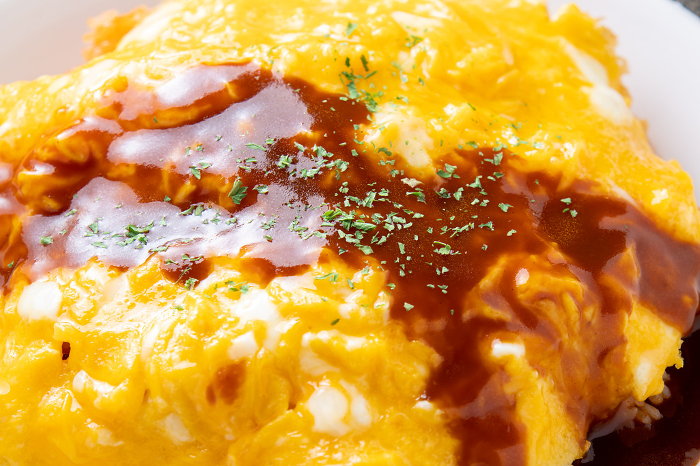 Close-up of omelette rice (unwrapped omelette rice with demi-glace sauce).