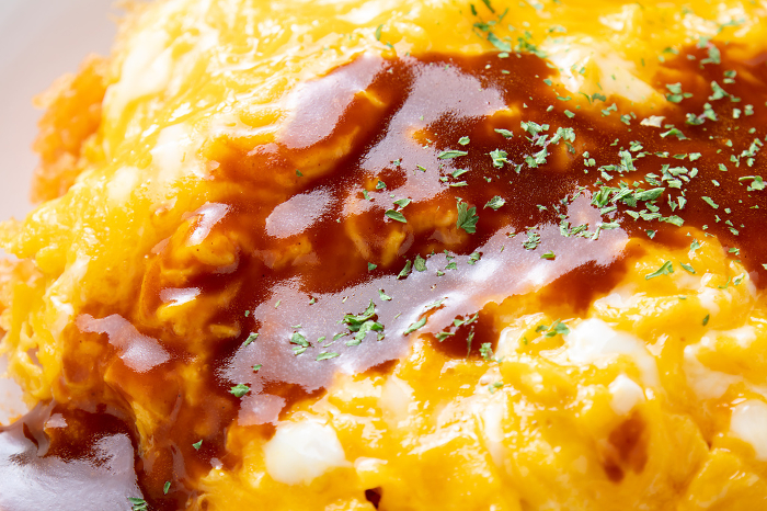 Close-up of omelette rice (unwrapped omelette rice with demi-glace sauce).
