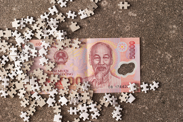 Vietnamese banknotes and jigsaw puzzle