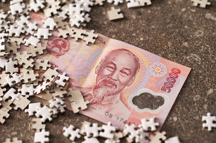 Vietnamese banknotes and jigsaw puzzle