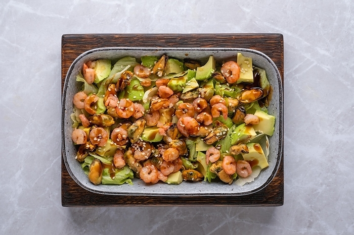 Top view of salad with shrimp, mussels and avocado, by Aleksei Isachenko