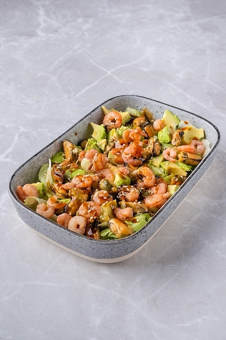 Bowl with iceberg lettuce salad with shrimp, mussels and avocado, by Aleksei Isachenko