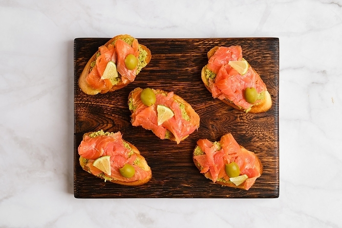 Top view of sandwiches with salted salmon and avocado, by Aleksei Isachenko
