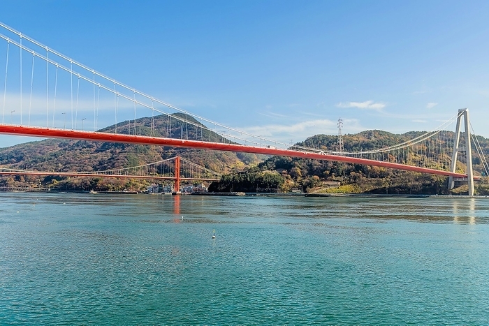 Suspension bridges over large body of water with mountains in background, South Korea, South Korea, Asia, by aminkorea