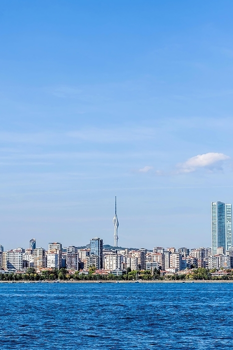 Coastal landscape of city buildings with communication tower in background in Turkey, by aminkorea