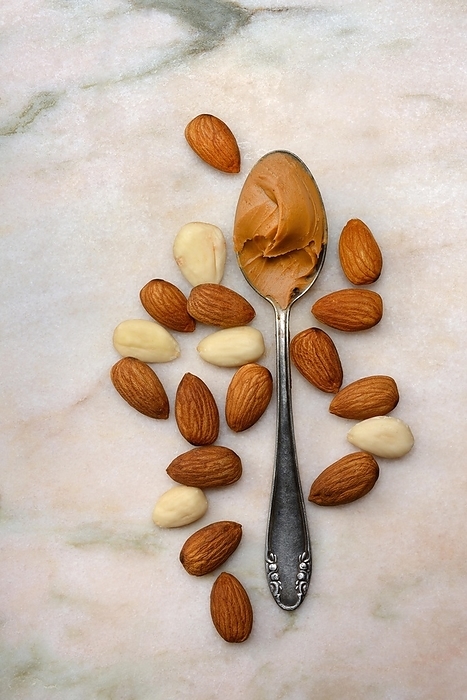 Almond cream in spoon and almonds, Prunus dulcis, by Jürgen Pfeiffer