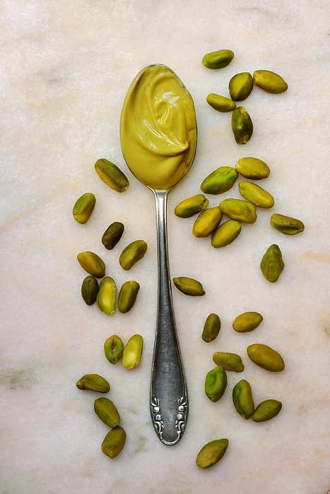 Pistachio cream in spoon and pistachios, pistachio vera, by Jürgen Pfeiffer