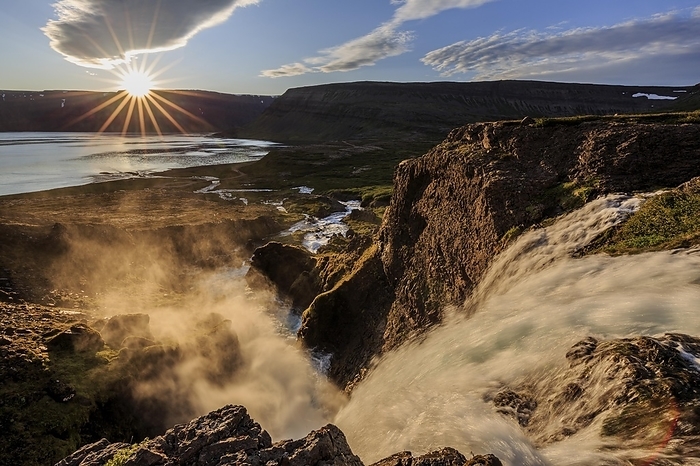 Iceland Waterfall backlit by midnight sun in front of mountains and coast, summer, Dynjandi, Westfjords, Iceland, Europe, by Martina Melzer