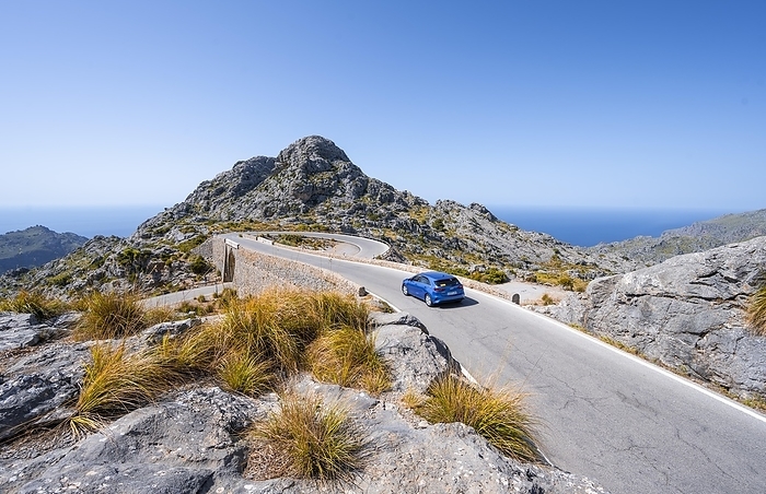 Car at the mountain pass with switchbacks to Sa Colobra, Nus de Sa Corbata road loop, Serra de Tramuntana, Majorca, Balearic Islands, Spain, Europe, by Moritz Wolf