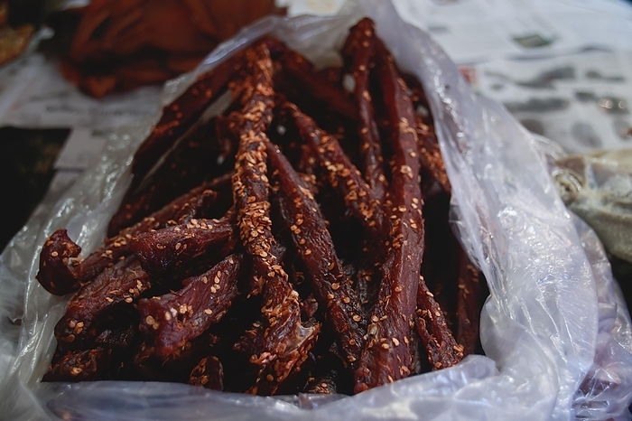 Close up to a bag of traditional cambodian beef jerky called sach ko ngeat sold in the local Samaki Market, showing the candid authentic khmer daily life, culture and livelihood in Kampot Cambodia, by MartinxMarie