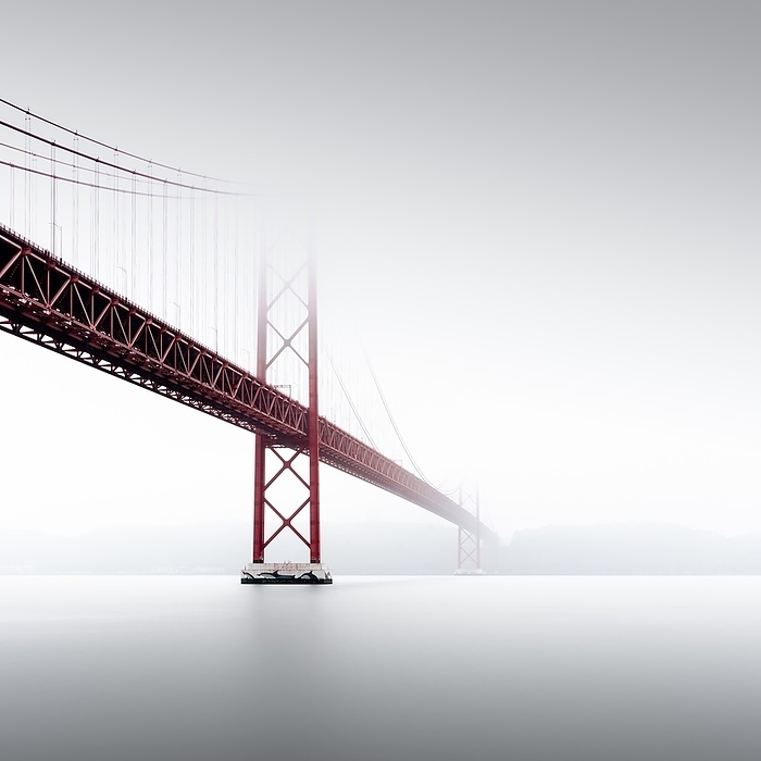 Minimalist long exposure of the Golden Gate Bridge's little sister. The Ponte 25 de Abril bridge over the Tagus River in Lisbon, Portugal, Europe, by Ronny Behnert