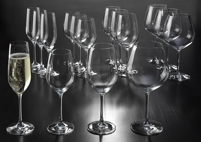 Wine glasses, champagne goblets, a filled champagne goblet, by Reinhard Rohner