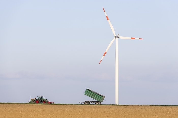 Tractor with trailer sowing grain in a field, wind turbine, wind farm, Swabian Alb, Baden-Württemberg, Germany, Europe, by Lilly