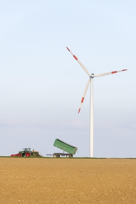Tractor with trailer sowing grain in a field, wind turbine, wind farm, Swabian Alb, Baden-Württemberg, Germany, Europe, by Lilly