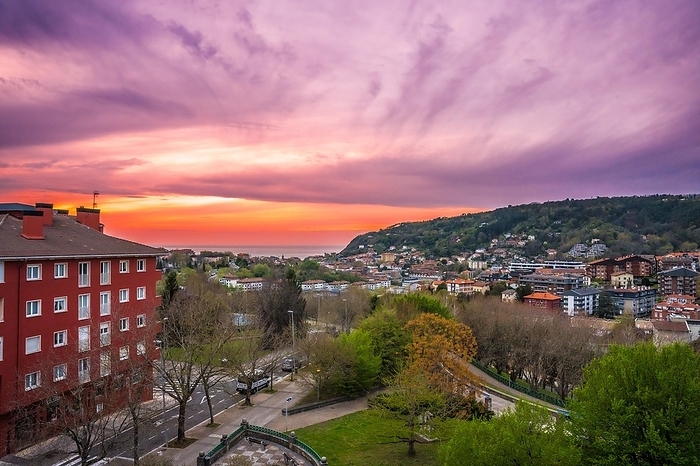Sunset in Donostia San Sebastian from a high neighborhood and the sea in the background. Basque Country, by Unai Huizi