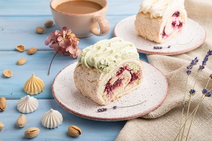 Roll biscuit cake with cream cheese and jam, cup of coffee on blue wooden background and linen textile. side view, close up, by ULADZIMIR ZGURSKI