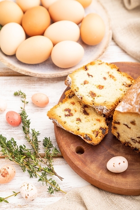 Homemade easter pie with raisins and eggs on plate on a white wooden background and linen textile. side view, close up, selective focus, by ULADZIMIR ZGURSKI