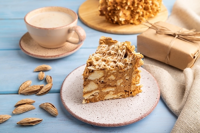 Traditional lithuanian cake shakotis with cup of coffee on blue wooden background and linen textile. side view, close up, by ULADZIMIR ZGURSKI