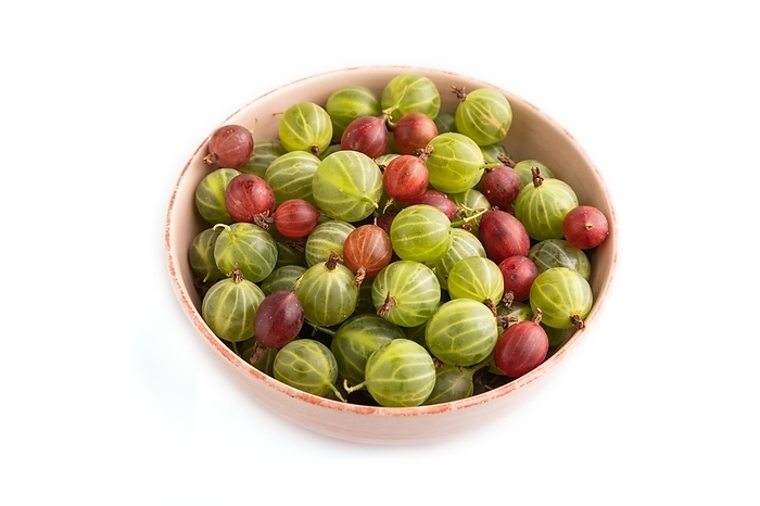 Fresh red and green gooseberry in ceramic bowl isolated on white background. side view, close up, by ULADZIMIR ZGURSKI