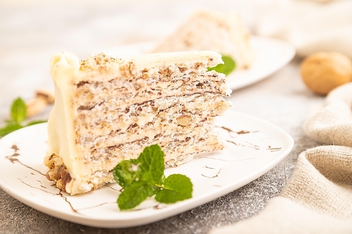 Walnut and almond cake on brown concrete background and linen textile. side view, close up, selective focus, by ULADZIMIR ZGURSKI