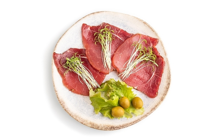 Slices of smoked salted meat with cilantro microgreen isolated on white background. Top view, flat lay, close up, by ULADZIMIR ZGURSKI