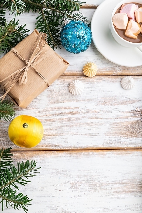 Christmas or New Year frame composition. Decorations, box, balls, cinnamon, ribbons, fir and spruce branches, cup of coffee, on a white wooden background. Top view, copy space, flat lay, by ULADZIMIR ZGURSKI