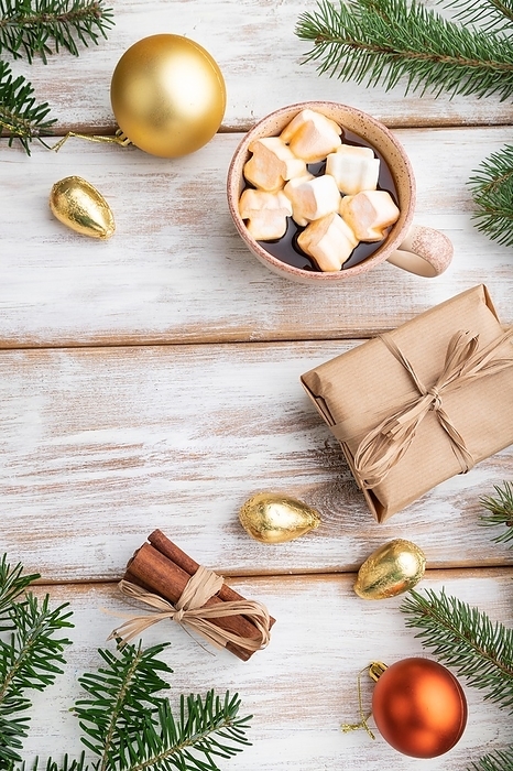 Christmas or New Year composition. Decorations, box, golden balls, cinnamon, fir and spruce branches, cup of coffee, on a white wooden background. Top view, copy space, flat lay, by ULADZIMIR ZGURSKI