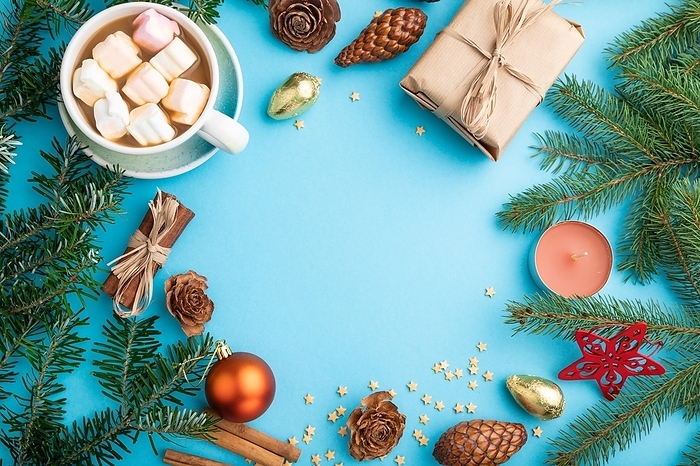 Christmas or New Year frame composition. Decorations, box, cinnamon, cones, fir and spruce branches, cup of coffee, on a blue paper background. Top view, copy space, flat lay, by ULADZIMIR ZGURSKI