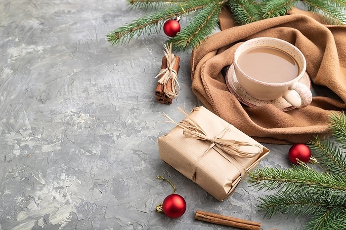 Christmas or New Year composition. Decorations, box, cinnamon, fir and spruce branches, cup of coffee, wool scarf on a gray concrete background. Side view, copy space, by ULADZIMIR ZGURSKI