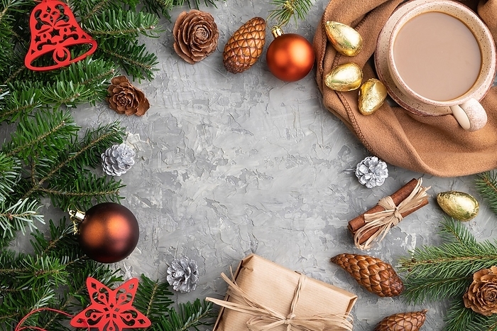 Christmas or New Year frame composition. Decorations, cones, cinnamon, fir and spruce branches, cup of coffee, wool scarf on a gray concrete background. Top view, copy space, flat lay, by ULADZIMIR ZGURSKI