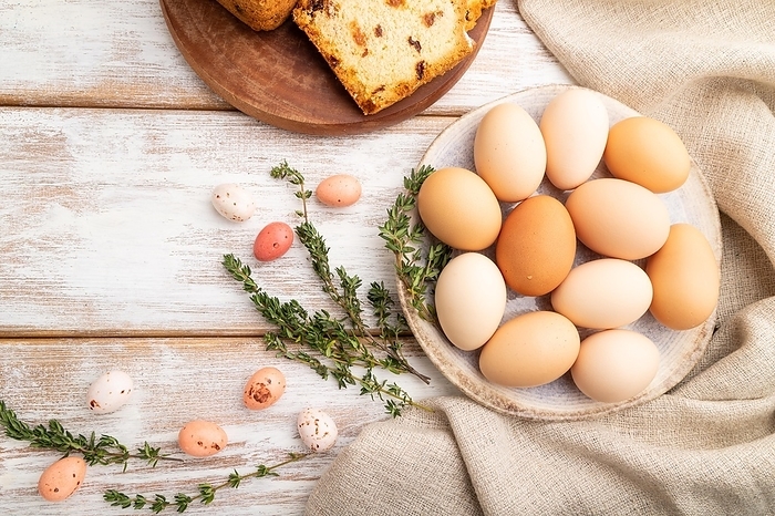 Homemade easter pie with raisins and eggs on plate on a white wooden background and linen textile. top view, flat lay, close up, by ULADZIMIR ZGURSKI
