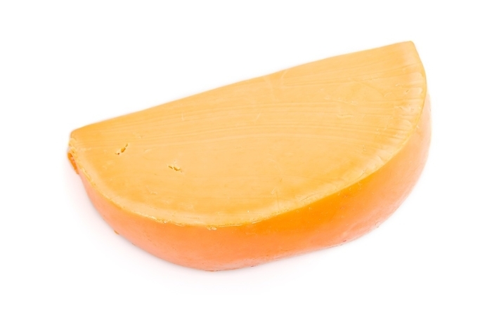 Piece of orange cheese isolated on white background. Top view, close up, by ULADZIMIR ZGURSKI