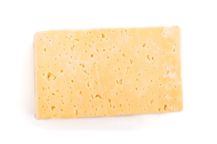 Piece of yellow cheese isolated on white background. Top view, close up, by ULADZIMIR ZGURSKI