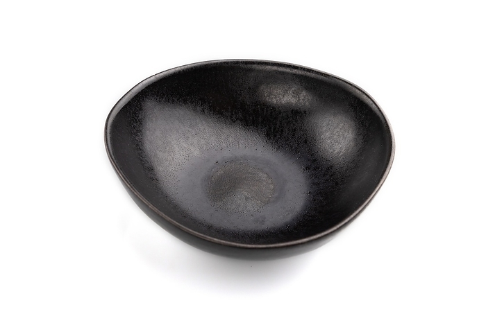 Empty black ceramic bowl isolated on white background. Side view, close up, by ULADZIMIR ZGURSKI