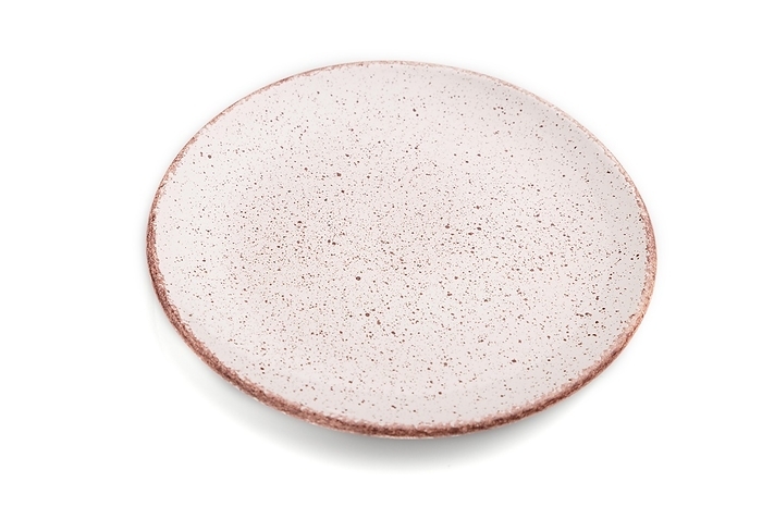 Empty pink dotted ceramic plate isolated on white background. Side view, close up, by ULADZIMIR ZGURSKI