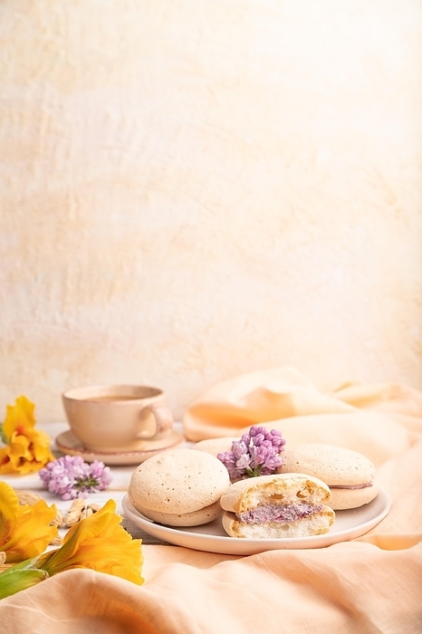 Meringues cakes with cup of coffee on a white background and orange linen textile. Side view, copy space, selective focus, by ULADZIMIR ZGURSKI