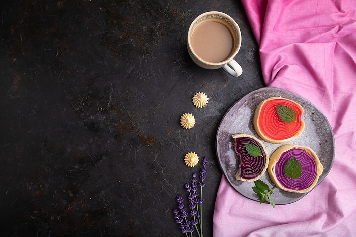 Sweet tartlets with jelly and milk cream with cup of coffee on a black concrete background and pink textile. top view, flat lay, copy space, by ULADZIMIR ZGURSKI