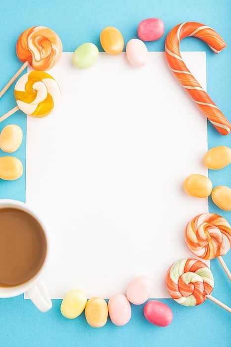 Composition with candies frame on blue pastel background. copy space, top view, flat lay, template, by ULADZIMIR ZGURSKI