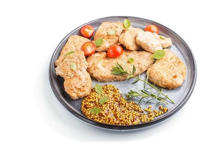 Fried pork chops with tomatoes and herbs on a gray ceramic plate isolated on white background. side view, close up, by ULADZIMIR ZGURSKI