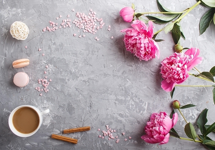 Pink peony flowers and a cup of coffee on a gray concrete background. Morninig, spring, fashion composition. Flat lay, top view, copy space, by ULADZIMIR ZGURSKI