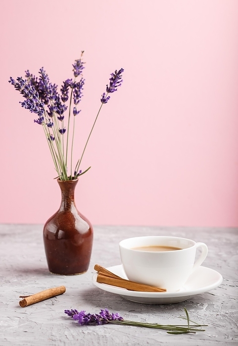 Purple lavender in ceramic jug and a cup of coffee on a gray and pink background. Morninig, spring, fashion composition. side view, close up, selective focus, by ULADZIMIR ZGURSKI