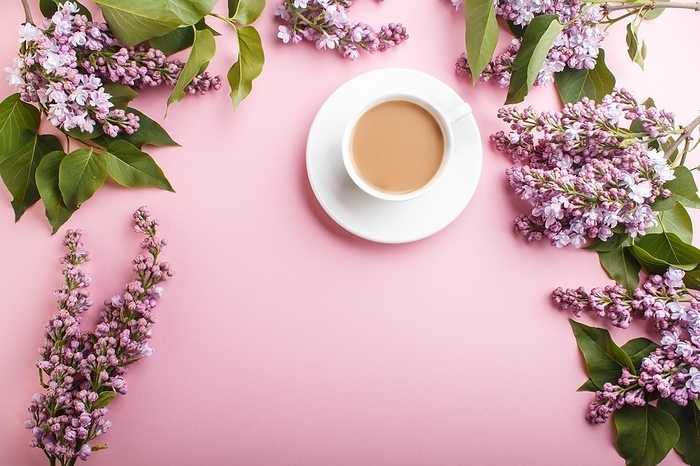 Purple lilac flowers and a cup of coffee on pastel pink background. Morninig, spring, fashion composition with copy space. Flat lay, top view, by ULADZIMIR ZGURSKI