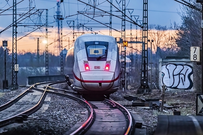 Germany Railway line with many overhead lines and railway signals, InterCityExpress ICE of Deutsche Bahn AG, rear lights in the evening light, Stuttgart, Baden W rttemberg, Germany, Europe, by Arnulf Hettrich