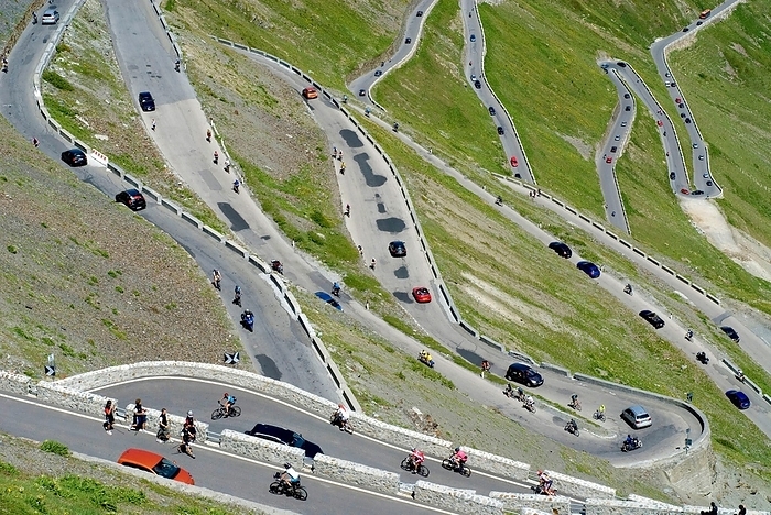 Italy Stelvio Pass with hairpin turns, much traffic in the summer season, busy and crowded with pedestrians, bikers, cars, traffic jam, South Tyrole, Alps, Italy, Europe, the picture is Digital compositing, Europe, by Dirk v. Mallinckrodt